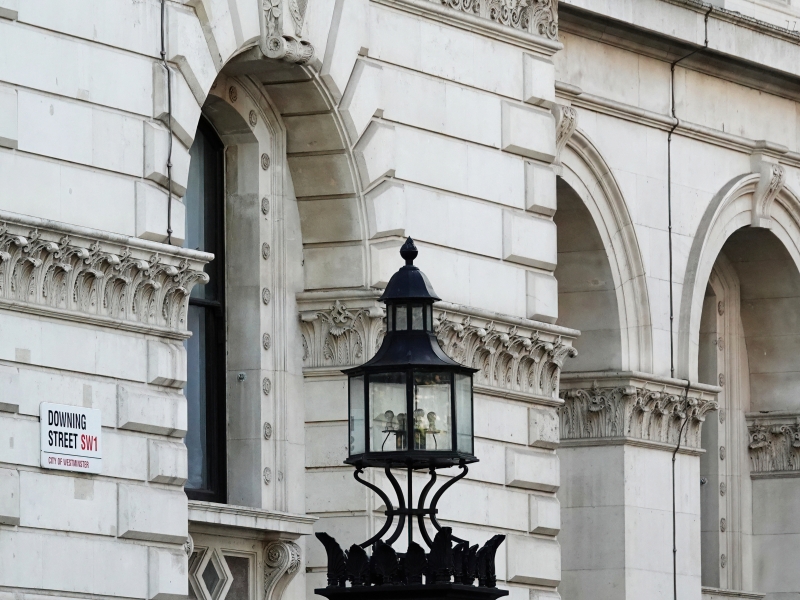 Downing Street sign on the wall of a building in Westminster
