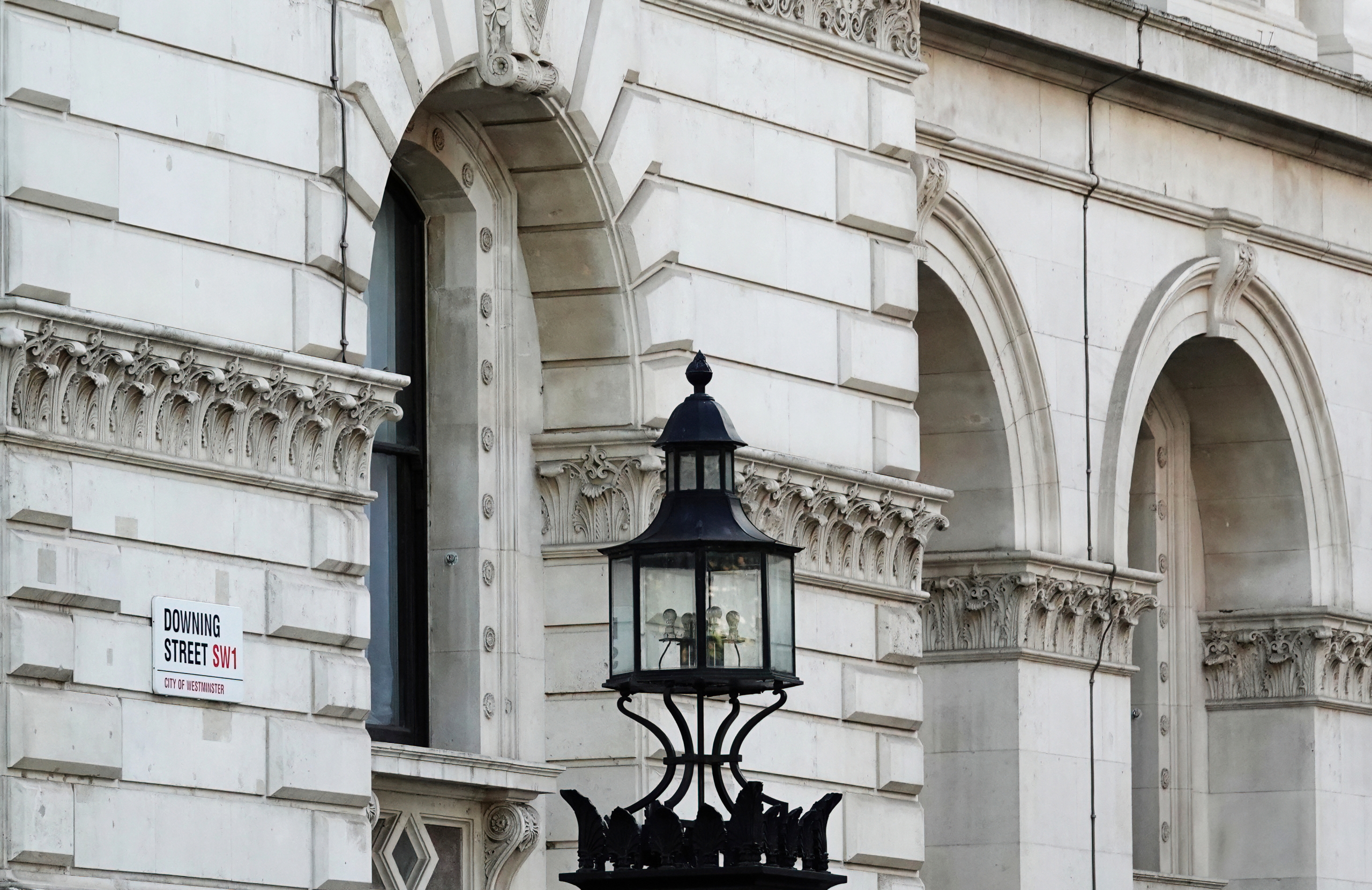 Downing Street sign on the wall of a building in Westminster