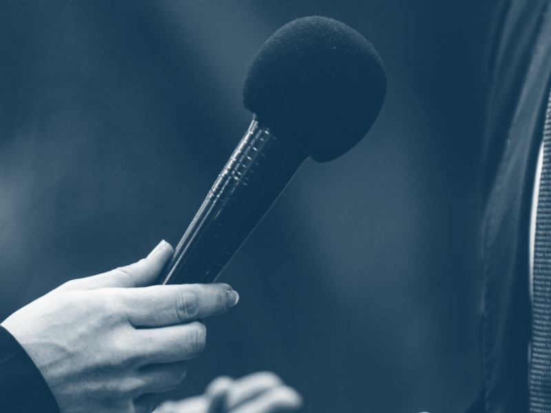 microphone being held up to person in suit