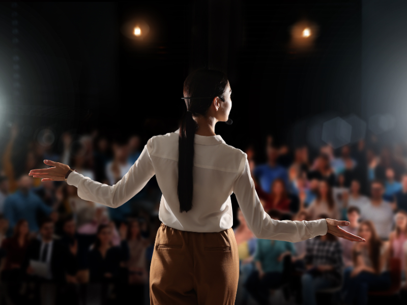 Person presenting in front of audience
