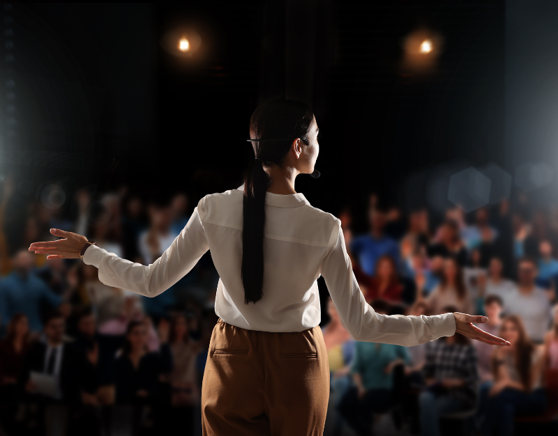 Person presenting in front of audience