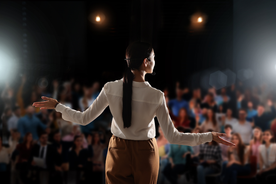 Person presenting in front of audience