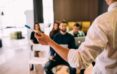 Person holding a marker pen presenting