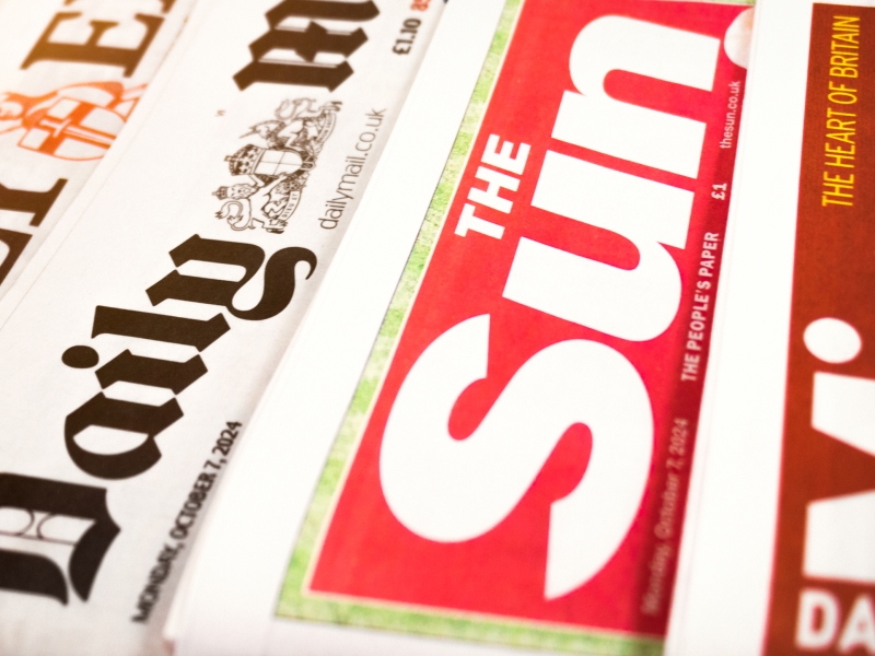 stack of different newspaper from a side angle