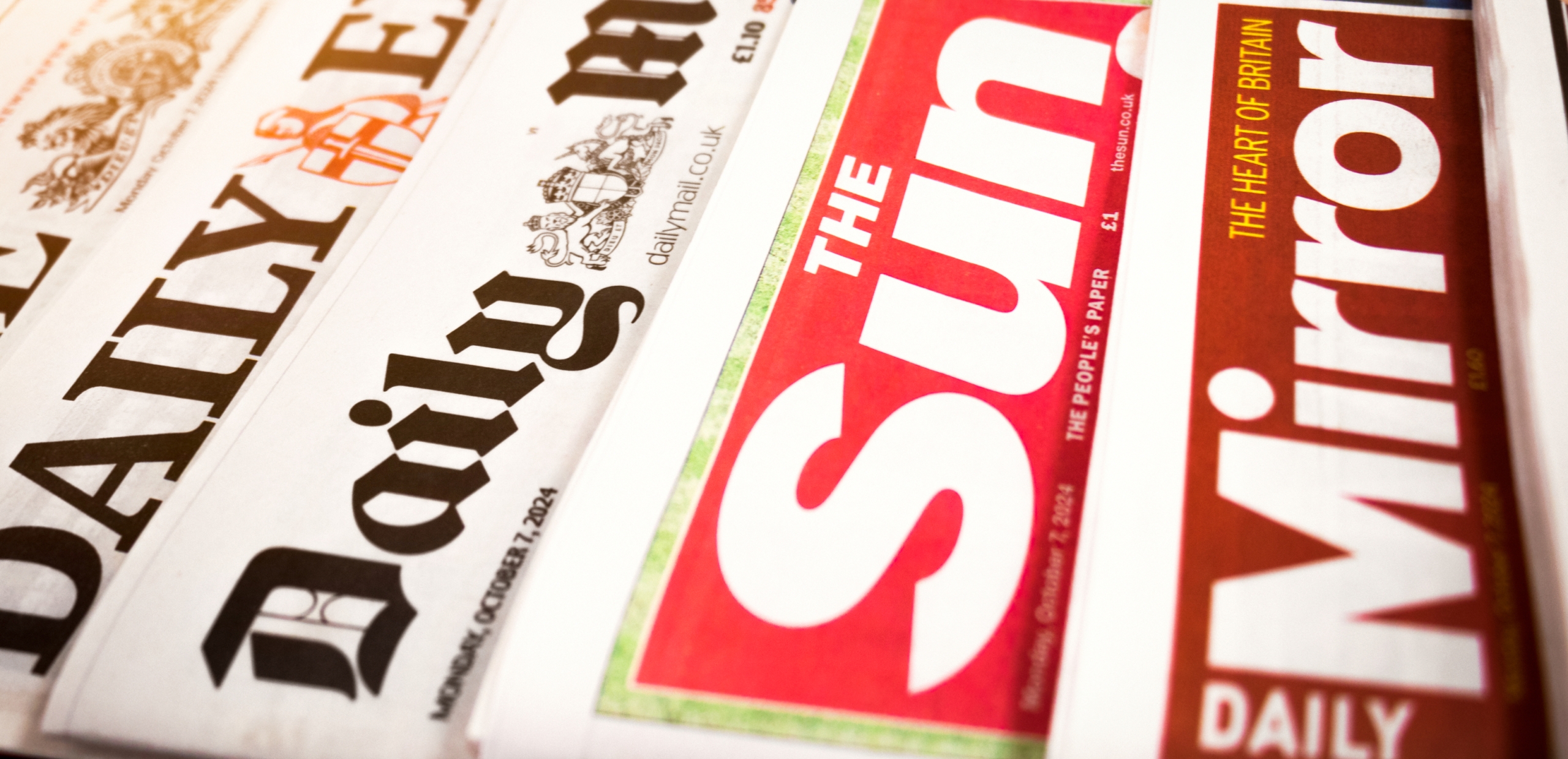 stack of different newspaper from a side angle