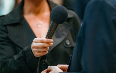 person holding microphone to another person