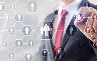 Person in suit rearranging shapes with people icons inside them