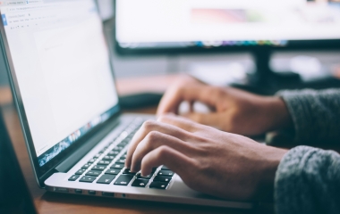 person typing on computer keyboard