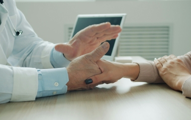care provider holding the hand of a patient