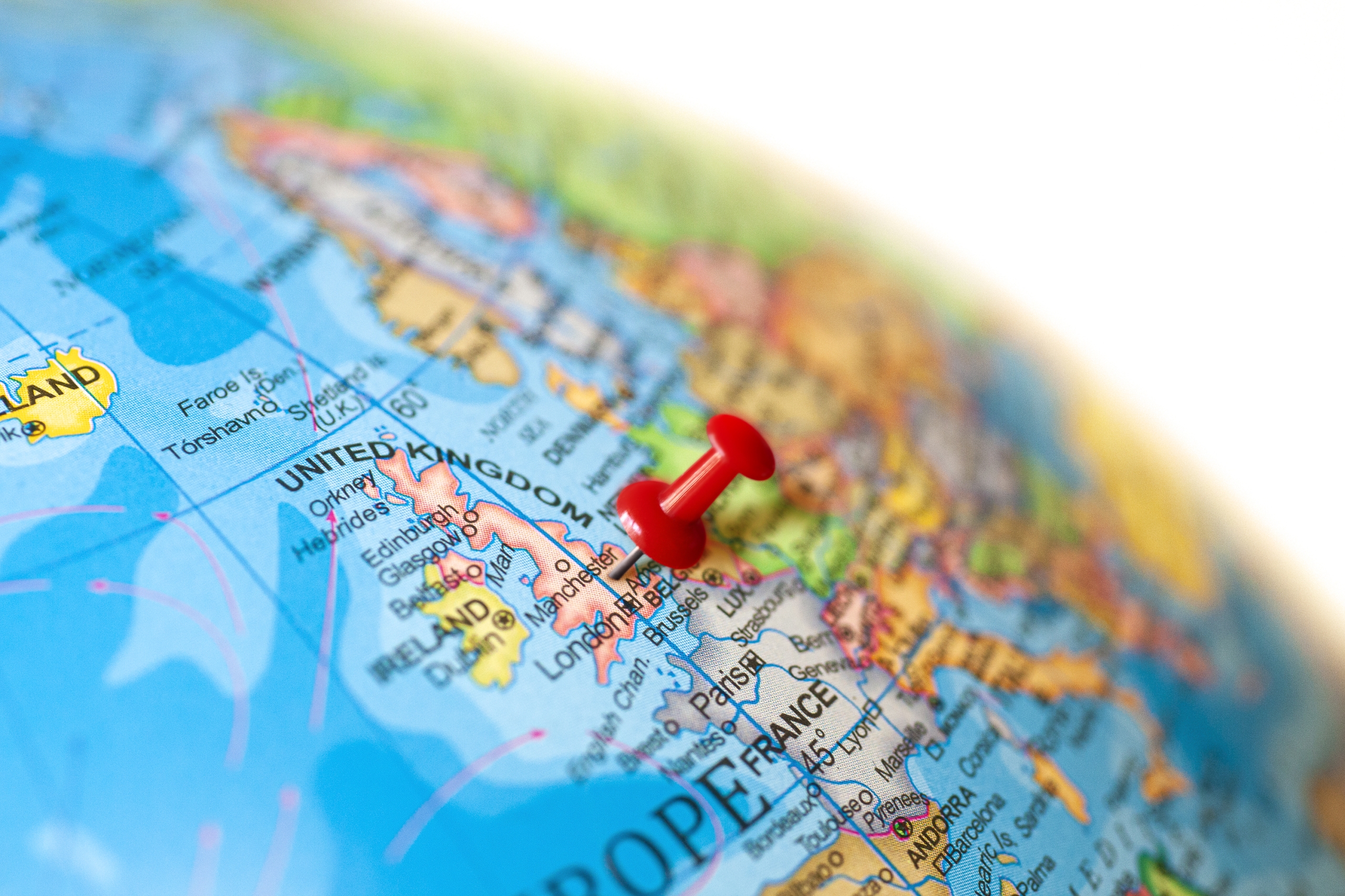 map of the world with a pin in Manchester